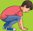 A boy crouched down with his hands on the ground.