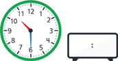 A clock with the hour hand pointing between “10” and “11” and the minute hand pointing to “6.” A blank digital clock.